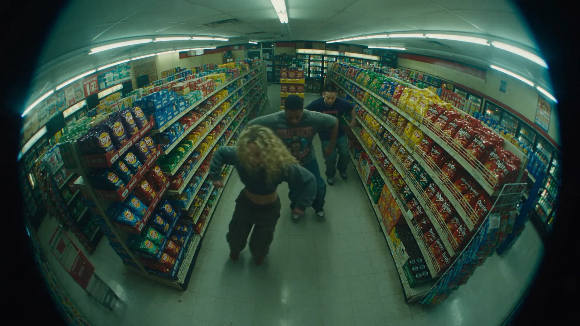 Friends dancing in a convenience store security camera frame